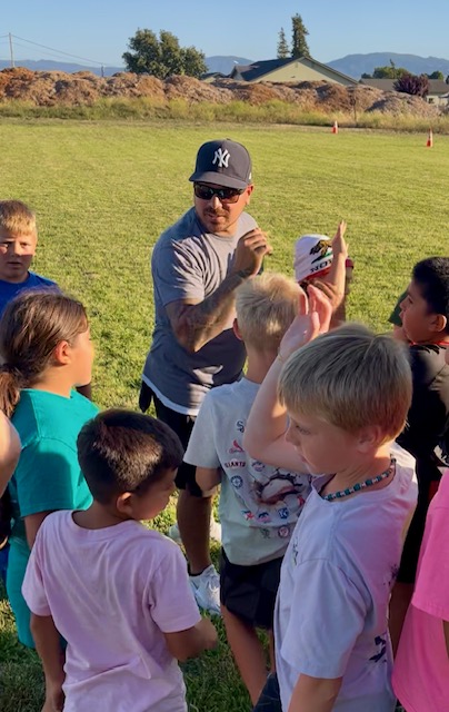 Coach Michael Morales with athletes