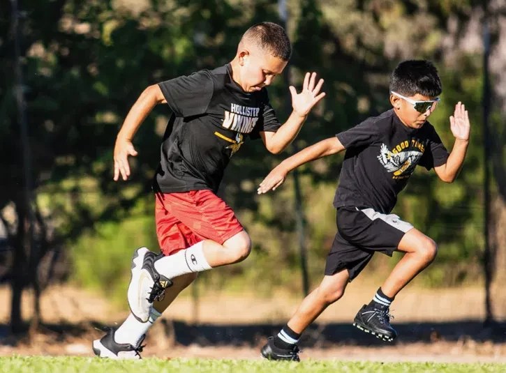 Athletes sprinting side by side during a lab session